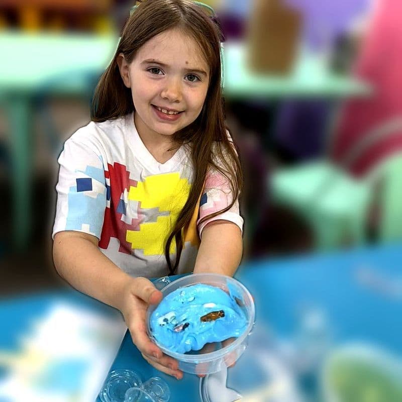 Girl holding blue slime