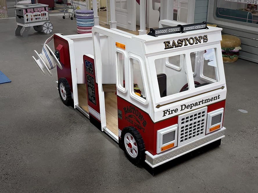 Easton's red and white Fire Department truck with an open side for climbing in